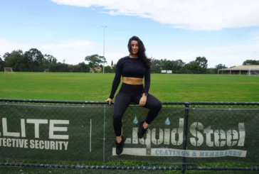 Woman sitting on fence