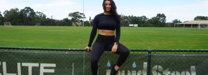 Woman sitting on fence